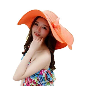 Women's foldable wide brim sun hat in bright orange with large bow for beach vacations