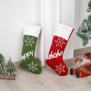 Pair of red and green plush Christmas stockings with faux fur trim and snowflake embroidery