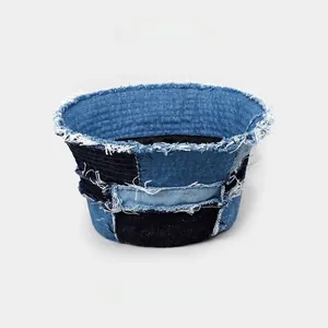 Close-up of patchwork denim bucket hat with frayed edges and contrast stitching texture