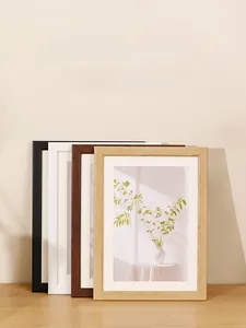 Detail of minimalist rounded edge picture frames in wood, black and white finishes
