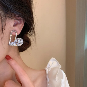 Sparkling silver heart stud earrings with zircons shown on a model for an elegant look