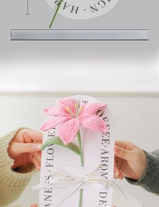 Handcrafted pink crochet lily flower with green leaves and Love Is Eternal ribbon detail