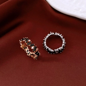 Macro view of vintage style gold and silver rings with black rectangular stones