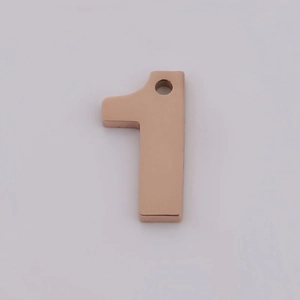 Detail view of rose gold stainless steel number 1 pendant for DIY jewelry making