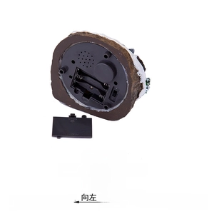 Detail of Christmas house base showing 3-way music and rotation switch with AAA battery slot