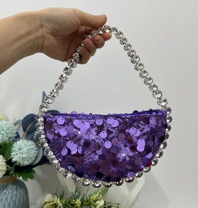 Detail of purple sequin evening handbag with sparkling crystal beaded top handle