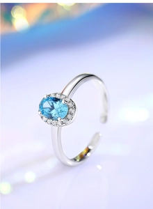 Macro view of S925 silver ring featuring blue oval gemstone with white zircon halo