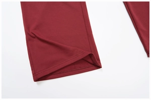 Close-up of maroon cotton sweatpants hem showing precise double-needle stitching quality