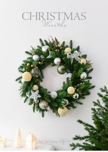 Detail of 60cm Christmas wreath with silver and gold ornaments on white wall