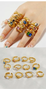 Detail of vintage irregular wave rings with moonstone accents in a flat lay display