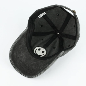 Detail view of the washed grey cotton baseball cap showing internal label and 100% cotton material