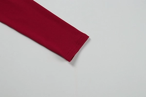 Detailed close-up of the red long sleeve cuff with high-quality reinforced stitching
