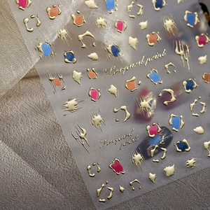 3D embossed leopard print nail stickers with metallic gold borders and vivid colors