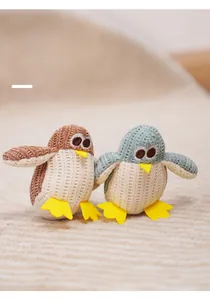 Detailed close-up of knitted penguin catnip toys with soft textures and embroidered eyes