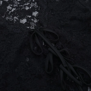 Close-up of intricate floral lace fabric and black satin ribbon lacing on a slim top