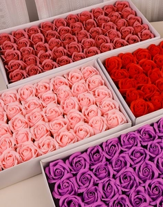 Detailed top view of bulk decorative soap rose heads in assorted pink and red colors