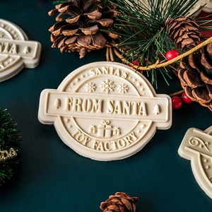 Christmas badge cookie stamp with Santa's toy factory engraving and festive decorations
