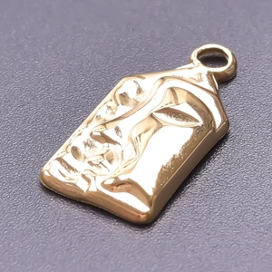 Close-up of golden rectangular 18k plated stainless steel pendant with face relief