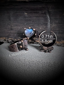 Vintage heart labradorite ring with bronze plating and blue flash on dark wooden base