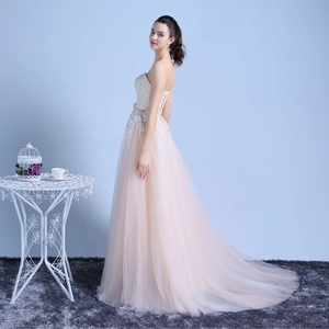 Elegant champagne strapless lace evening gown with a tulle train and lace-up back