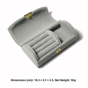 Detail of gray velvet travel jewelry box with gold clasp and 10.3x5.7x3.5cm dimensions