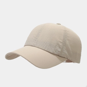 Detail of breathable laser-cut vents on lightweight beige quick-dry baseball cap