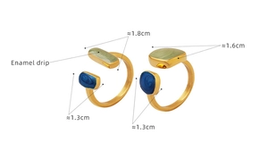 Detailed view of adjustable gold-plated rings featuring blue and green enamel drip art
