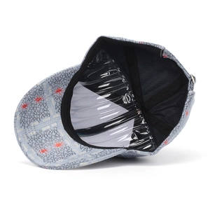 Detail view of baseball cap interior with grey cracked fabric and red star embroidery