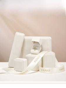 Detailed view of white velvet jewelry display set with ribbon and elegant ring gift boxes