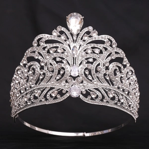 Detailed macro shot of a silver zircon pageant crown with crystal wave patterns on black background