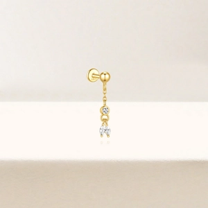 Detailed close-up of S925 sterling silver stamp on a gold-plated teardrop zircon earring