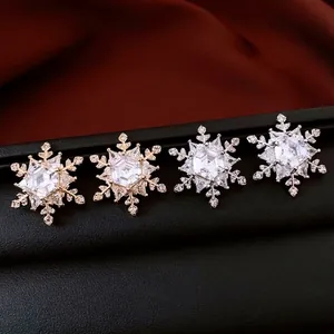 Gold and silver hexagon snowflake stud earrings set with sparkling cubic zirconia crystals