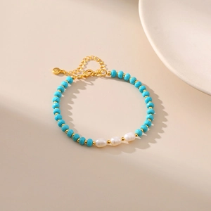 Detail of freshwater pearl and blue turquoise beaded bracelet with gold lobster clasp