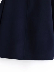 Detailed close-up of heavy wool fabric texture and reinforced vertical stitching on the hem