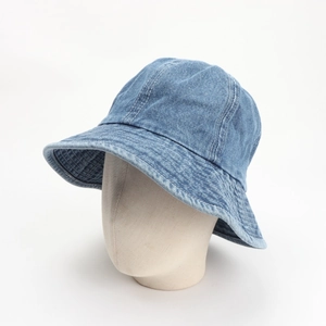 Detail of light blue denim bucket hat featuring white contrast stitching on the brim