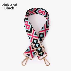 Close-up of pink and black geometric woven wide strap with gold metal swivel hooks