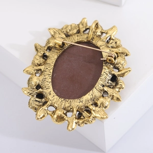 Detail view of the vintage gold brooch back featuring intricate metalwork and pin closure
