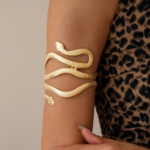 Detail shot of a multi-layer gold snake arm cuff with intricate scale textures
