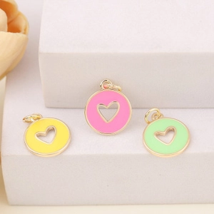 Detailed view of colorful heart-shaped metal charms with gold frames on a white display