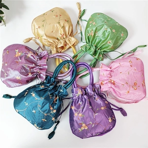 Top view of colorful satin drawstring bags with floral embroidery in six vibrant colors