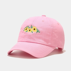 Close-up of sunflower embroidery details on a pink cotton twill baseball cap fabric