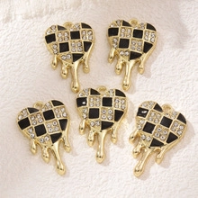 Macro view of five heart-shaped black and white checkerboard pendants with crystals