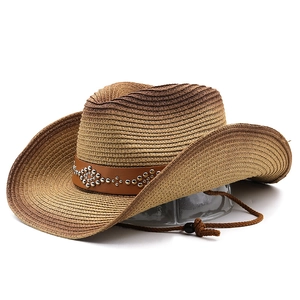 Detail of western straw cowboy hat with gradient finish and studded leather band