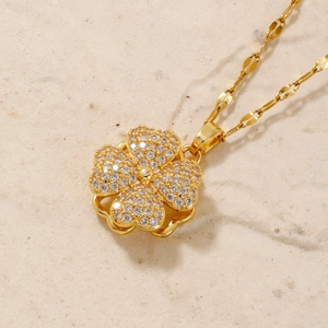 Golden necklace featuring a sparkling four-leaf clover pendant set with white zircons