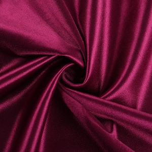 Détail rapproché montrant la texture de soie élégante et les plis doux du tissu de robe magenta