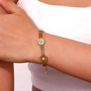 Detailed shot of 18K gold plated mesh chain bracelet with turquoise sunflower charms