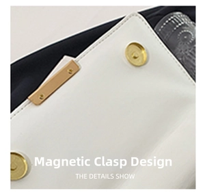 Detailed view of the magnetic snap closure on a white leather chain bag with gold hardware
