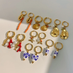 7-pair gold hoop earring set with ceramic pearls shells and resort style charms