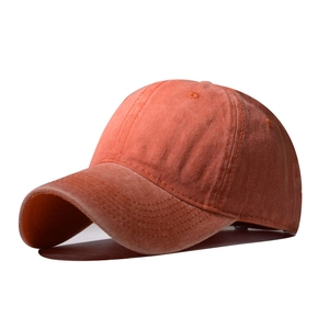 Classic washed cotton baseball cap in rust orange featuring a vintage street style design