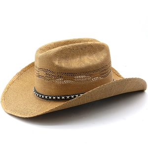 Detailed macro view of woven straw cowboy hat featuring breathable side mesh and band